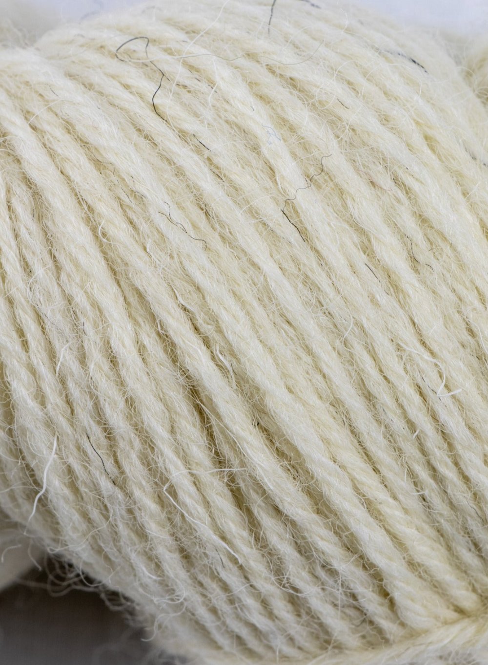 Close up of Clapdale Wool hand knit hank in natural undyed cream colour