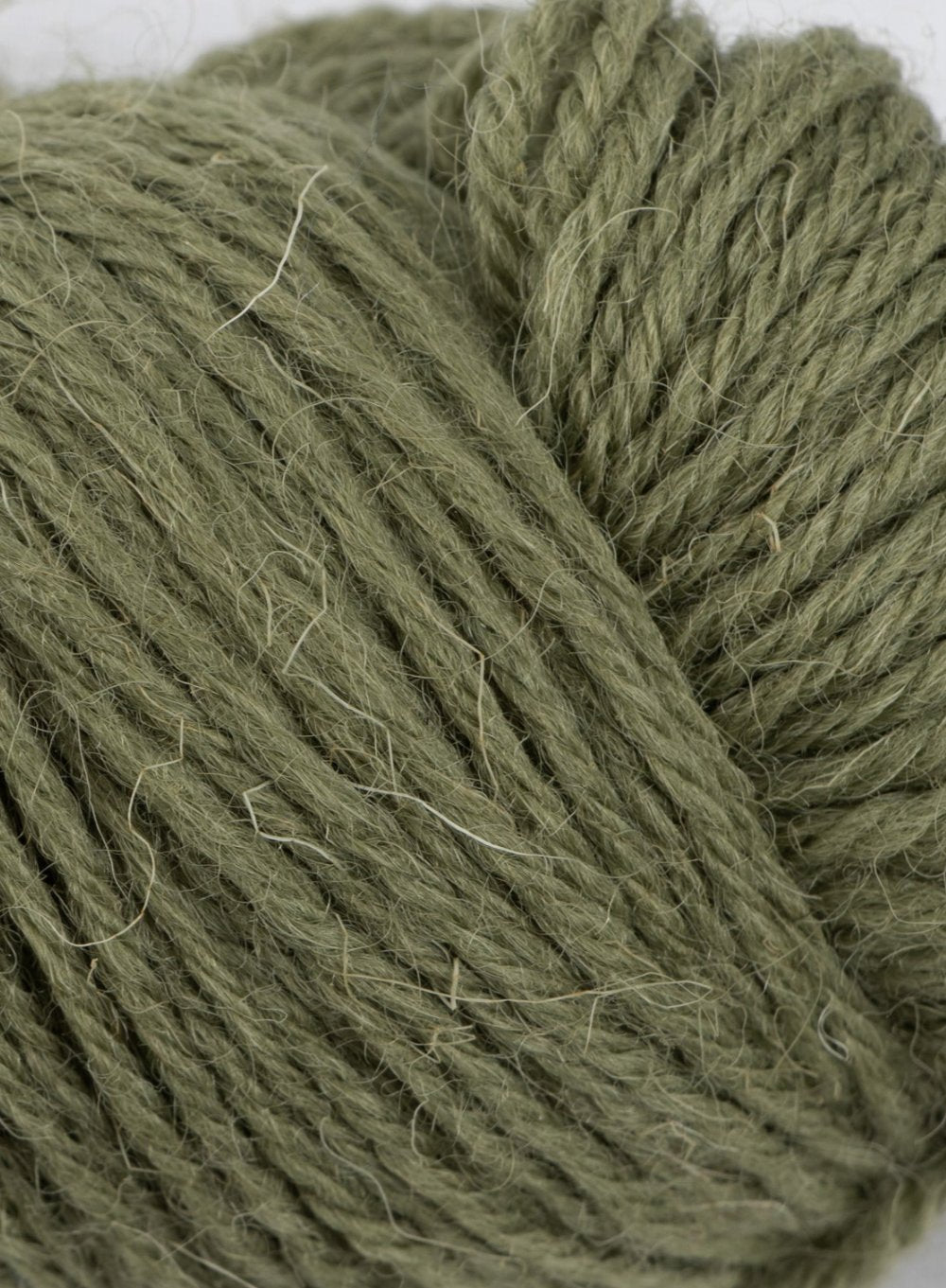 Close up ofClapdale Wool hand knit hank in olive green colour