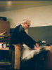 Man hand trimming sheepskin rug on bench